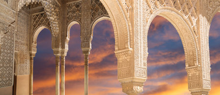 Arches in Islamic (Moorish) style (against the sunset) in Alhambra, Granada, Spain
