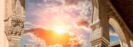 Arches in Islamic (Moorish) style (against the sunset) in Alhambra, Granada, Spainの写真素材