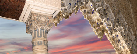 Arches in Islamic (Moorish) style (against the sunset) in Alhambra, Granada, Spain