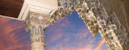 Arches in Islamic (Moorish) style (against the sunset) in Alhambra, Granada, Spain