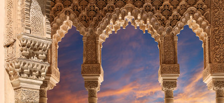 Arches in Islamic (Moorish) style (against the sunset) in Alhambra, Granada, Spainの写真素材