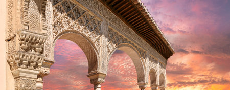 Arches in Islamic (Moorish) style (against the sunset) in Alhambra, Granada, Spainの写真素材