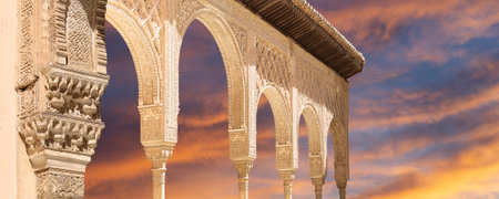 Arches in Islamic (Moorish) style (against the sunset) in Alhambra, Granada, Spainの写真素材