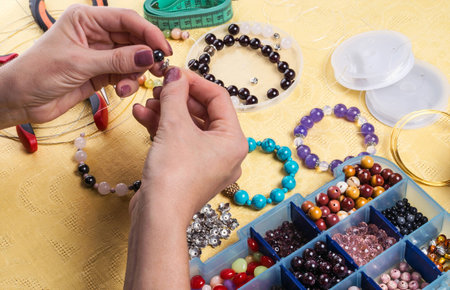Making bracelet of colorful beads.の写真素材