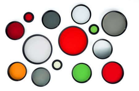 Glass round filters of different colors are isolated on white background.の写真素材