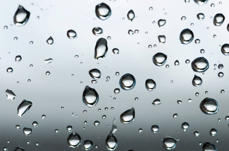 Drops of rain on the window glass on a blurred background. Selective focus.の写真素材