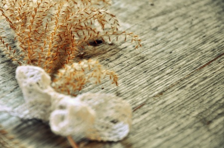 Dry flower on grey wood with lace bowの写真素材