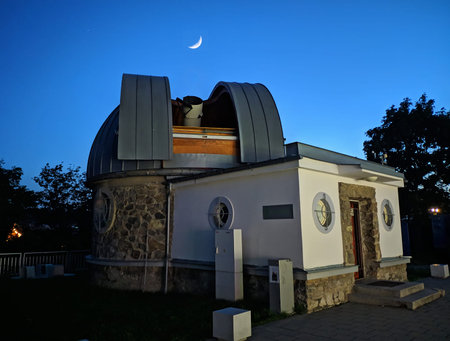 astronomical observatory. Telescope in the building. Crescent moon in the blue sky. Scientific and...