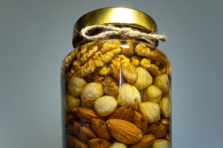 Jar with honey and nuts. Glass jar with natural and healthy food. organic food conceptの写真素材