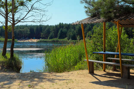 Small beach with a gazebo on the lake on a summer sunny dayの写真素材