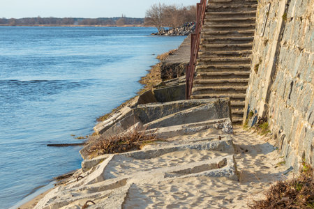 Destroyed river embankment and old stairs, collapsed concrete blocks and slabsの写真素材