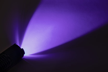 Light from an ultraviolet LED flashlight with a UV wavelength of 365 nmの写真素材