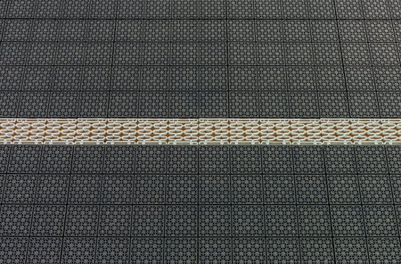 Modern flooring puzzle in plastic with holes in black and white with holes