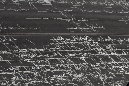 Cracks in the road surface of a multi-lane highway are filled with squiggly tar (resin). Asphalt road after repairの写真素材