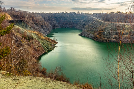 Mining quarry flooded with water. Green lake in a large granite quarry. Mining and extraction of...