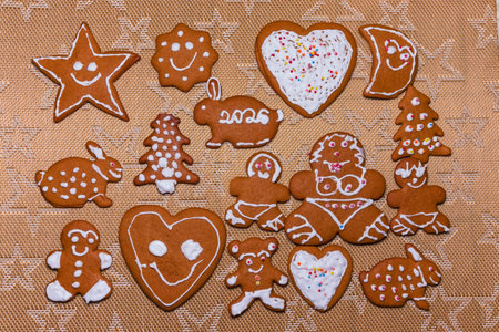 Homemade Christmas gingerbread cookies decorated and covered with white icing for the New Year 2026....