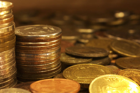 A bunch of golden metallic coins and two pillars made of coins