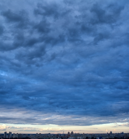 Dramatic overcast sky in city, heavy sky, panoramaの写真素材