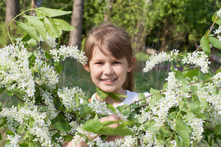 Girl smiling with a bouquet of cherry blossomsの写真素材