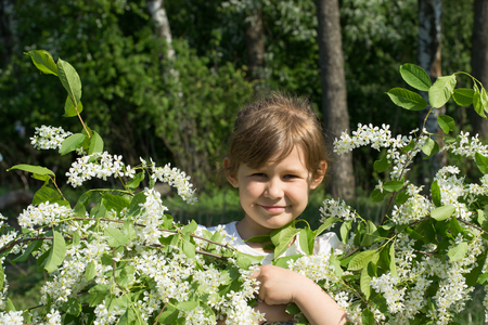 Girl smiling with a bouquet of cherry blossomsの写真素材