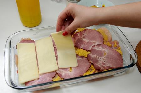 Preparing meal specialty with smoked ham and cheeseの写真素材