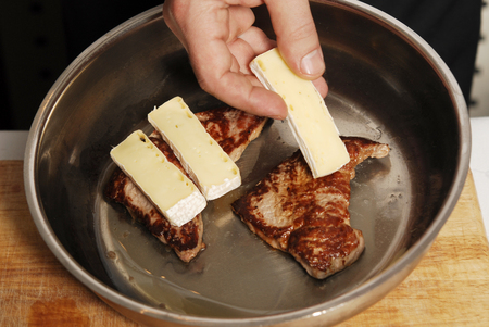 Preparing of chicken white meat with brie cheeseの写真素材