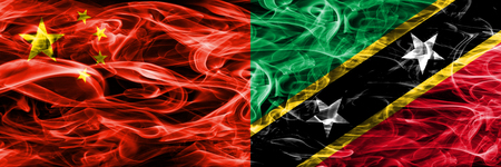 China vs Saint Kitts and Nevis smoke flags placed side by sideの写真素材