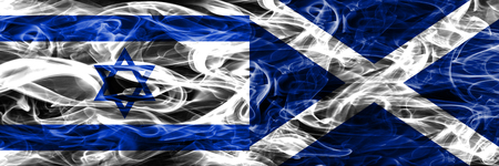Israel vs Scotland smoke flags placed side by side. Israeli and Scotland flag togetherの写真素材