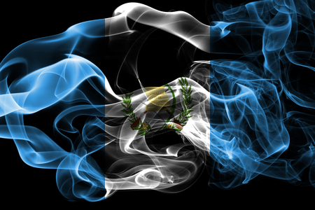 National flag of Guatemala made from colored smoke isolated on black background. Abstract silky wave background.の写真素材