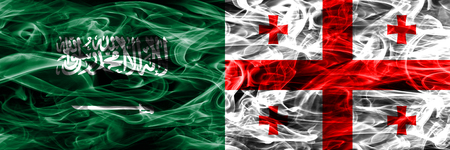 Saudi Arabia vs Georgia smoke flags placed side by side. Thick colored silky smoke flags of Saudi Arabia and Georgiaの写真素材