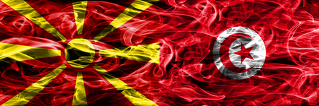 Macedonia vs Tunisia colorful concept smoke flags placed side by sideの写真素材