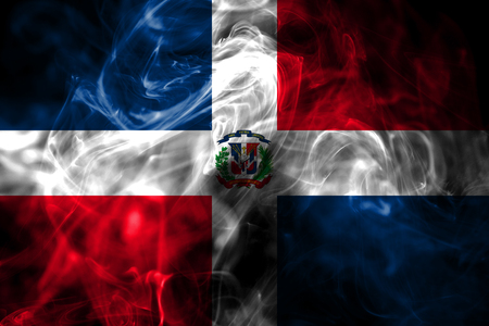 National flag of Dominican Republic made from colored smoke isolated on black background. Abstract silky wave background.の写真素材