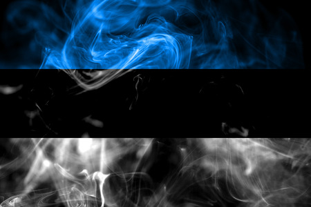 National flag of Estonia made from colored smoke isolated on black background. Abstract silky wave background.の写真素材