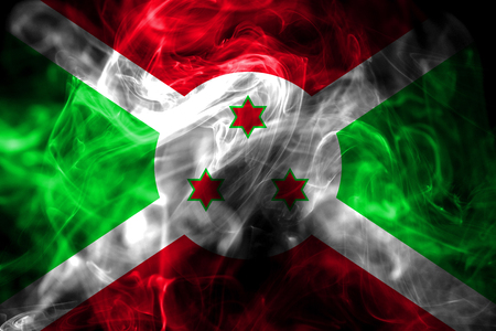 National flag of Burundi made from colored smoke isolated on black background. Abstract silky wave background.の写真素材