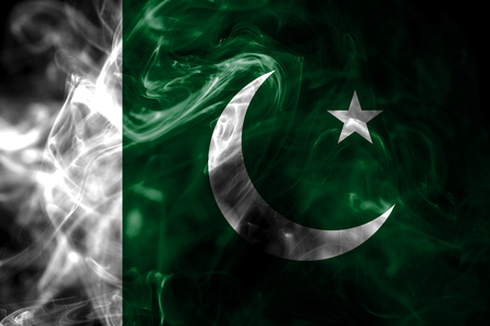 National flag of Pakistan made from colored smoke isolated on black background. Abstract silky wave background.の写真素材