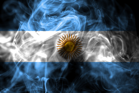 National flag of Argentina made from colored smoke isolated on black background. Abstract silky wave background.の写真素材