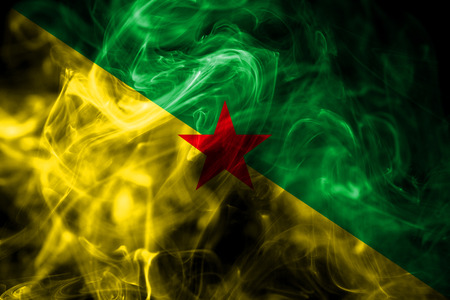 National flag of French Guiana made from colored smoke isolated on black background. Abstract silky wave background.の写真素材