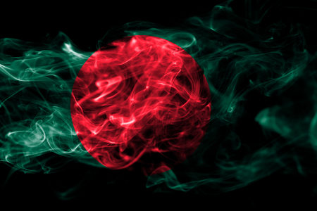 National flag of Bangladesh made from colored smoke isolated on black background. Abstract silky wave backgroundの写真素材