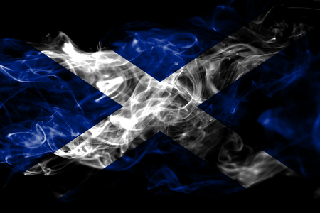 National flag of Scotland made from colored smoke isolated on black background. Abstract silky wave backgroundの写真素材