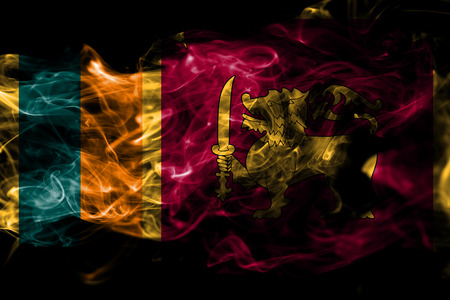 National flag of Sri Lanka made from colored smoke isolated on black background. Abstract silky wave backgroundの写真素材