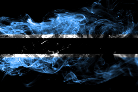 National flag of Botswana made from colored smoke isolated on black background. Abstract silky wave backgroundの写真素材