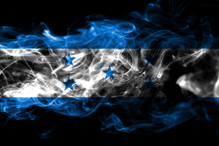 National flag of Honduras made from colored smoke isolated on black background. Abstract silky wave backgroundの写真素材
