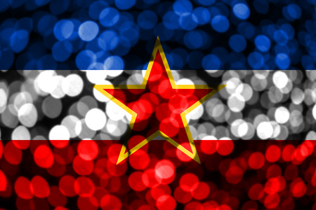 Yugoslavia abstract blurry bokeh flag. Christmas, New Year and National day concept flag.の写真素材