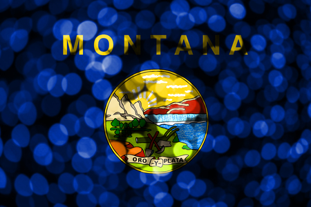 Montana abstract blurry bokeh flag. Christmas, New Year and National day concept flag. United States of America.の写真素材