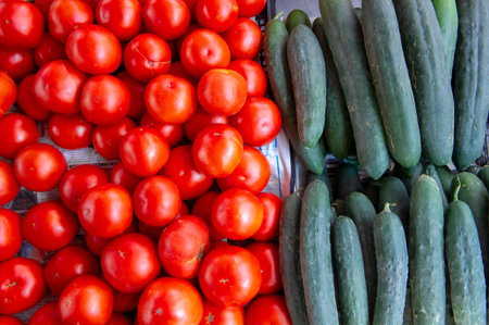 Heap of whole wet tomatoes and cucumbers. Top view point