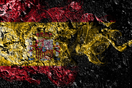 Spain smoky mystical flag on the old dirty wall backgroundの写真素材