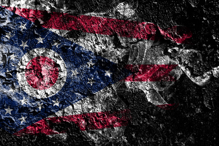 Ohio smoky mystical flag on the old dirty wall backgroundの写真素材