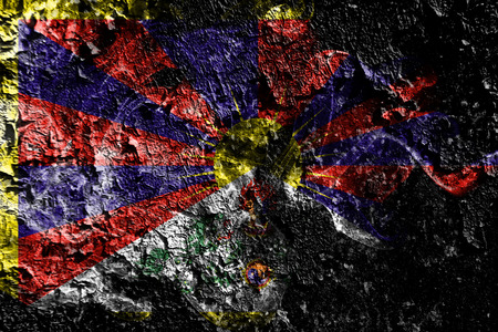 Tibet  smoky mystical flag on the old dirty wall backgroundの写真素材