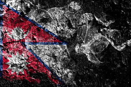 Nepal smoky mystical flag on the old dirty wall backgroundの写真素材