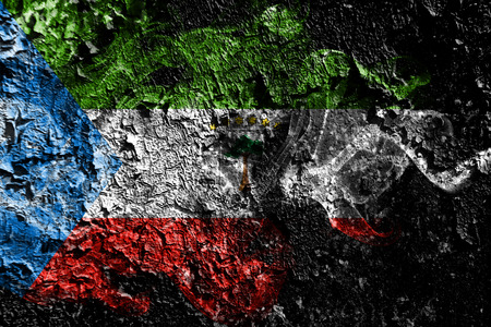 Equatorial Guinea smoky mystical flag on the old dirty wall backgroundの写真素材
